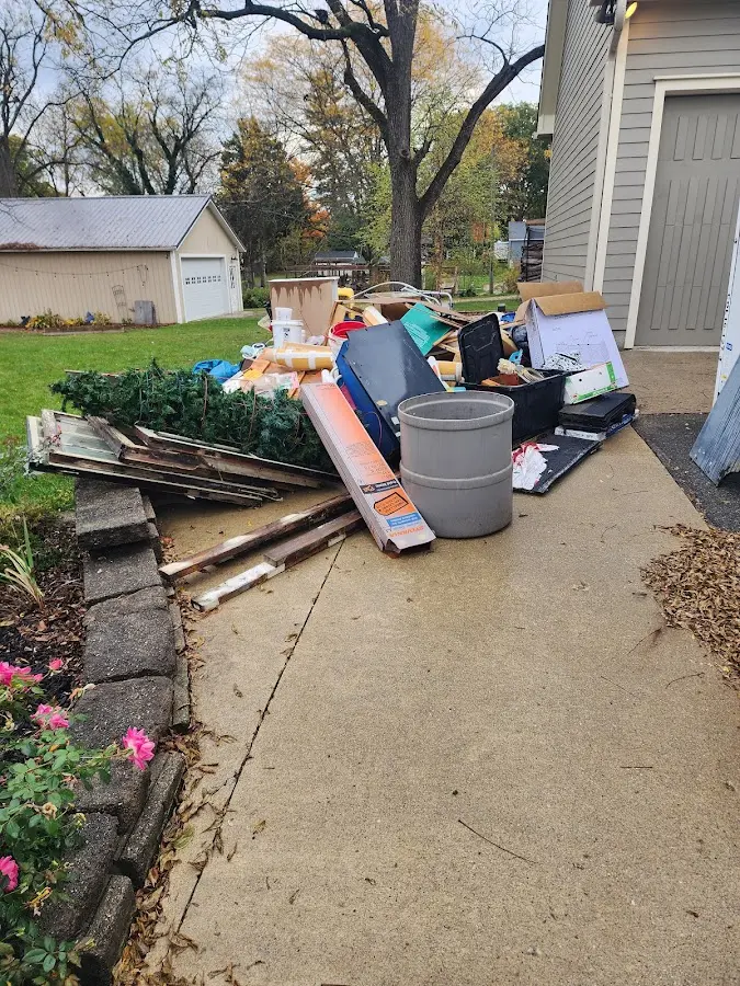 Dumpster being loaded with debris for 12 Yard Dumpster Rental in Millvale